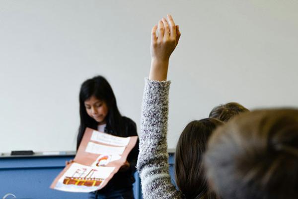 student raising hand in class